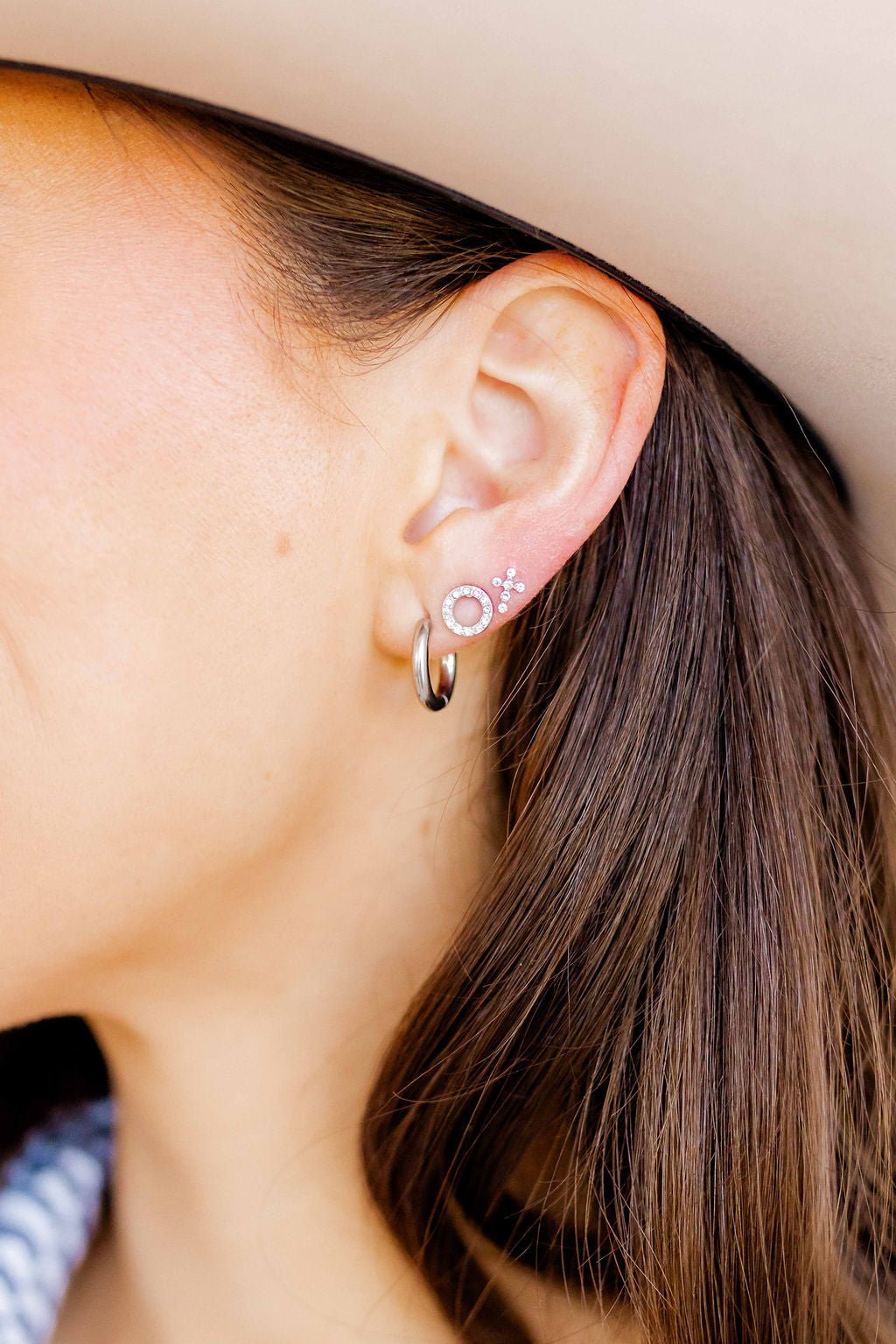 LINNY CO Scarlett Hoop Silver 14mm huggie earrings for kids & little girls — hypoallergenic, waterproof stainless steel, shown on model.