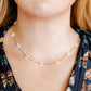 LINNY CO Gracie Flower Pearl necklace for kids & little girls — hypoallergenic, waterproof stainless steel, shown on model.