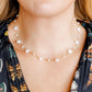 LINNY CO Kai Seashell Pearl necklace for kids & little girls — hypoallergenic, waterproof stainless steel, shown on model.