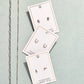 LINNY CO Miles Silver necklace for kids & little girls — hypoallergenic, waterproof stainless steel, flat-lay styling.