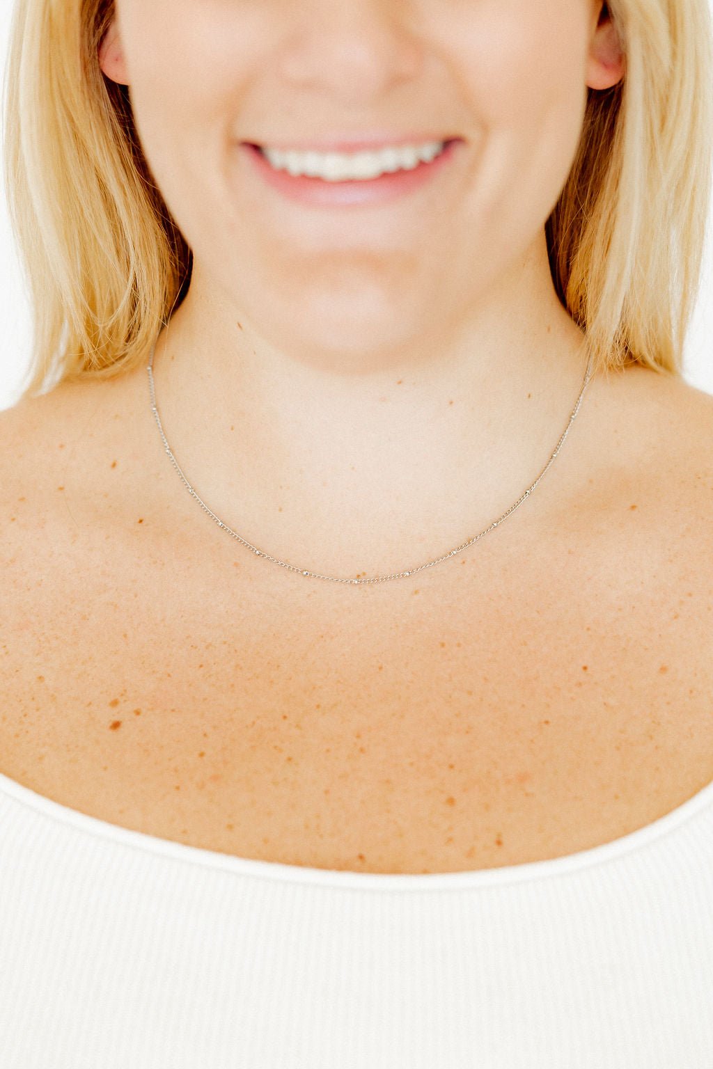 LINNY CO Miles Silver necklace for kids & little girls — hypoallergenic, waterproof stainless steel, shown on model.