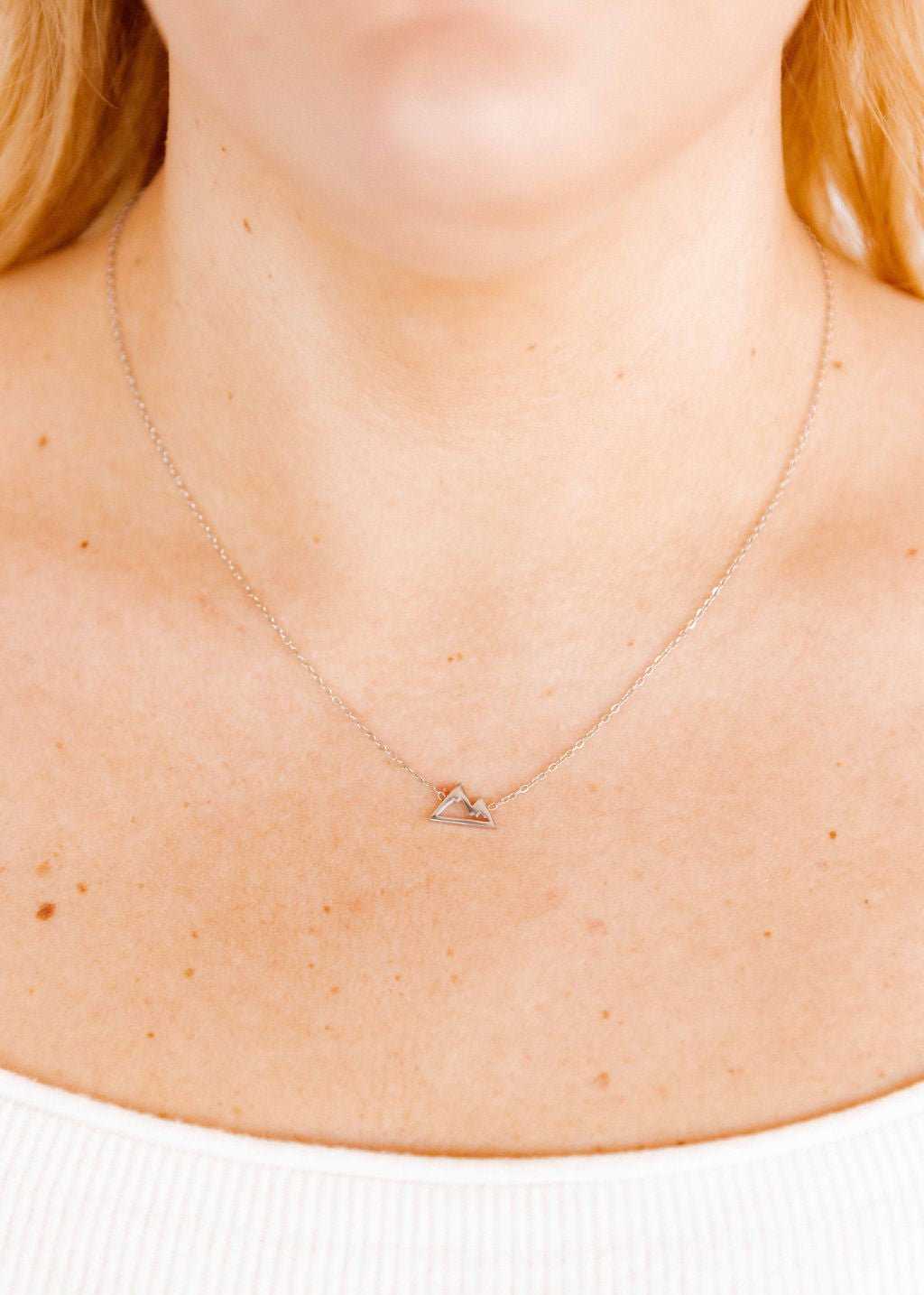 LINNY CO Mountain Silver necklace for kids & little girls — hypoallergenic, waterproof stainless steel, shown on model.