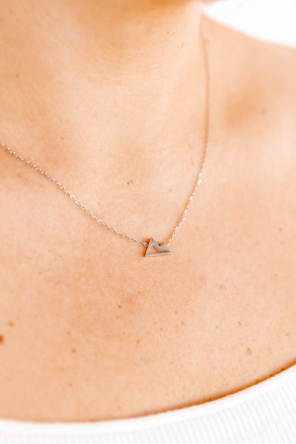 LINNY CO Mountain Silver necklace for kids & little girls — hypoallergenic, waterproof stainless steel, shown on model.