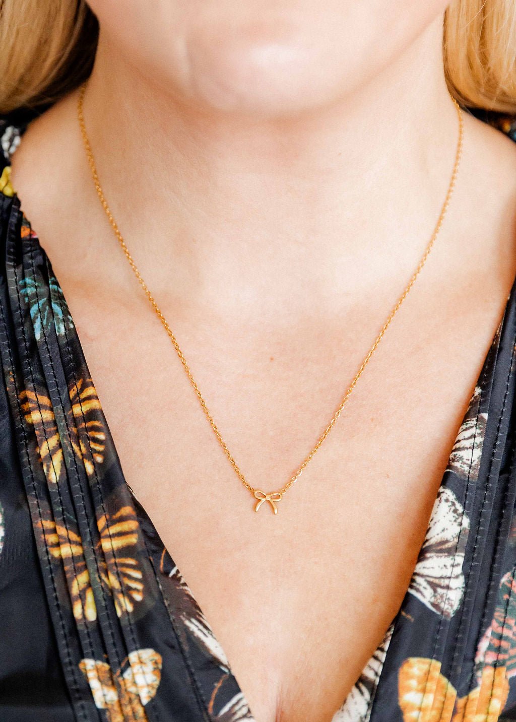 LINNY CO Sadie Bow Gold necklace for kids & little girls — hypoallergenic, waterproof stainless steel, shown on model.