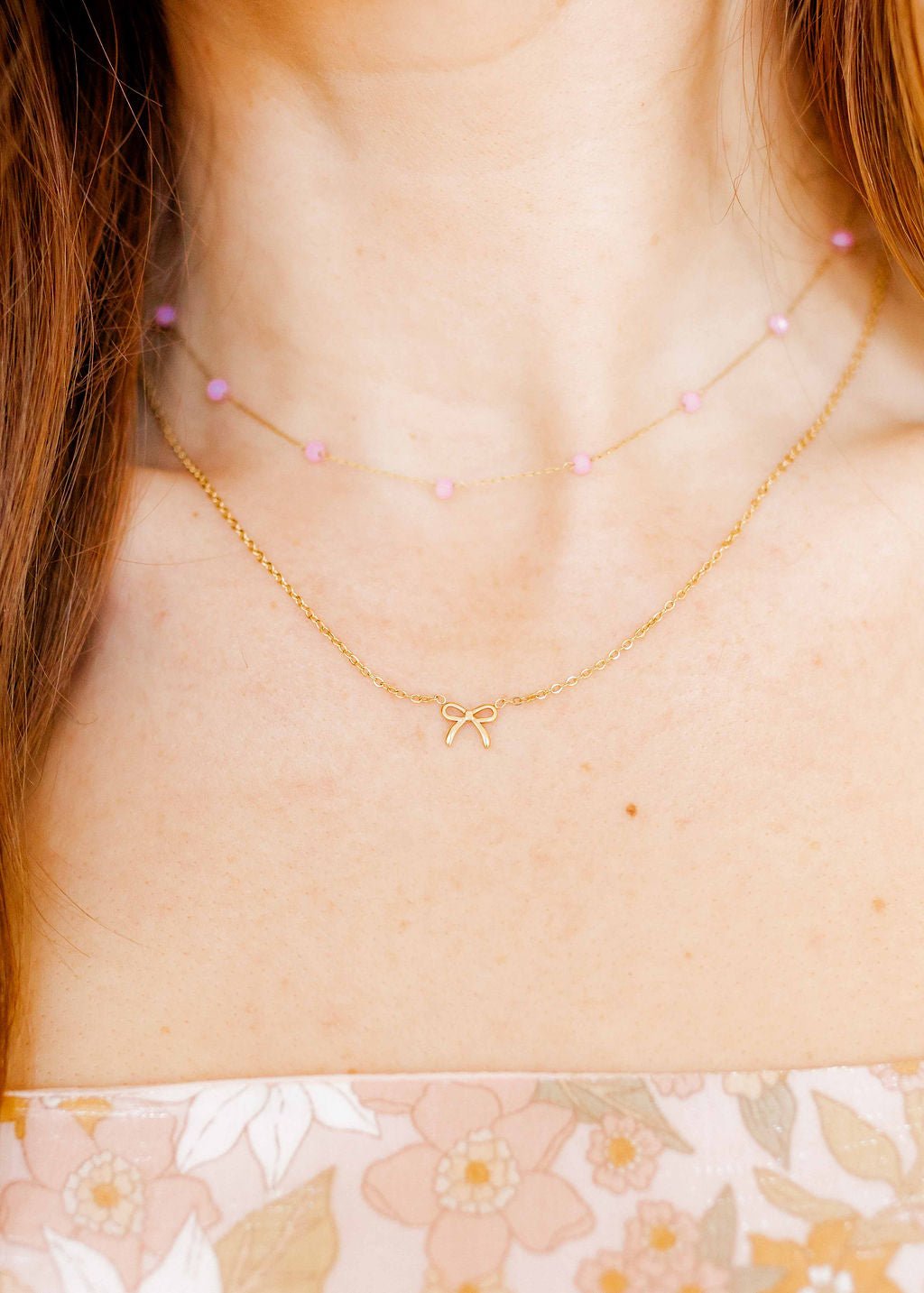 LINNY CO Sadie Bow Gold necklace for kids & little girls — hypoallergenic, waterproof stainless steel, shown on model.
