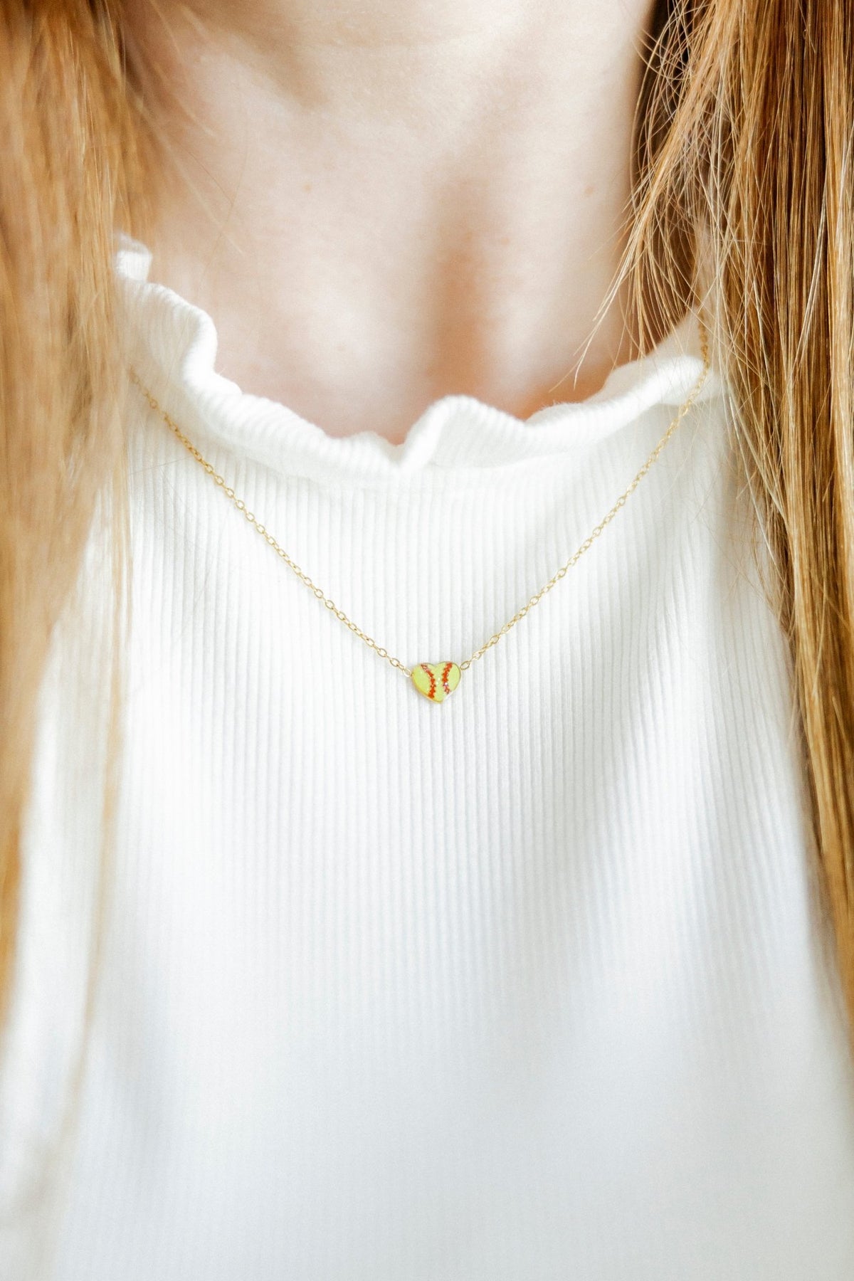 LINNY CO Softball necklace for kids & little girls — hypoallergenic, waterproof stainless steel, shown on model.