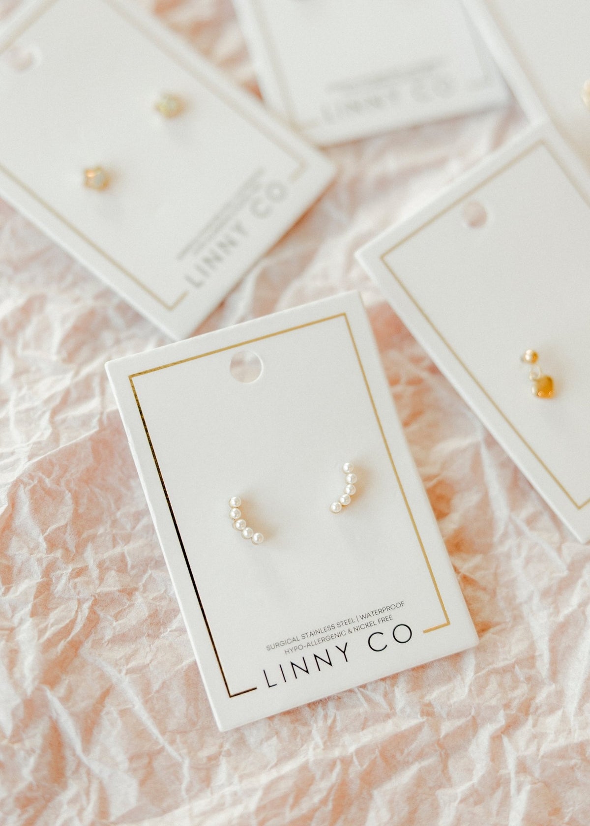 LINNY CO Abigail Pearl Gold screwback stud earrings for kids & little girls — hypoallergenic, waterproof stainless steel with secure screwback backs, flat-lay styling.