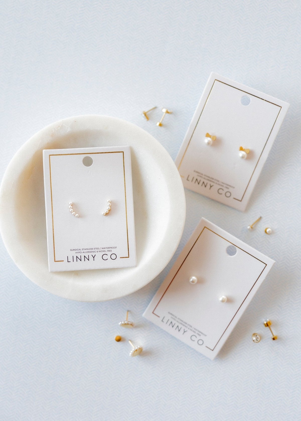 LINNY CO Abigail Pearl Gold screwback stud earrings for kids & little girls — hypoallergenic, waterproof stainless steel with secure screwback backs, flat-lay styling.