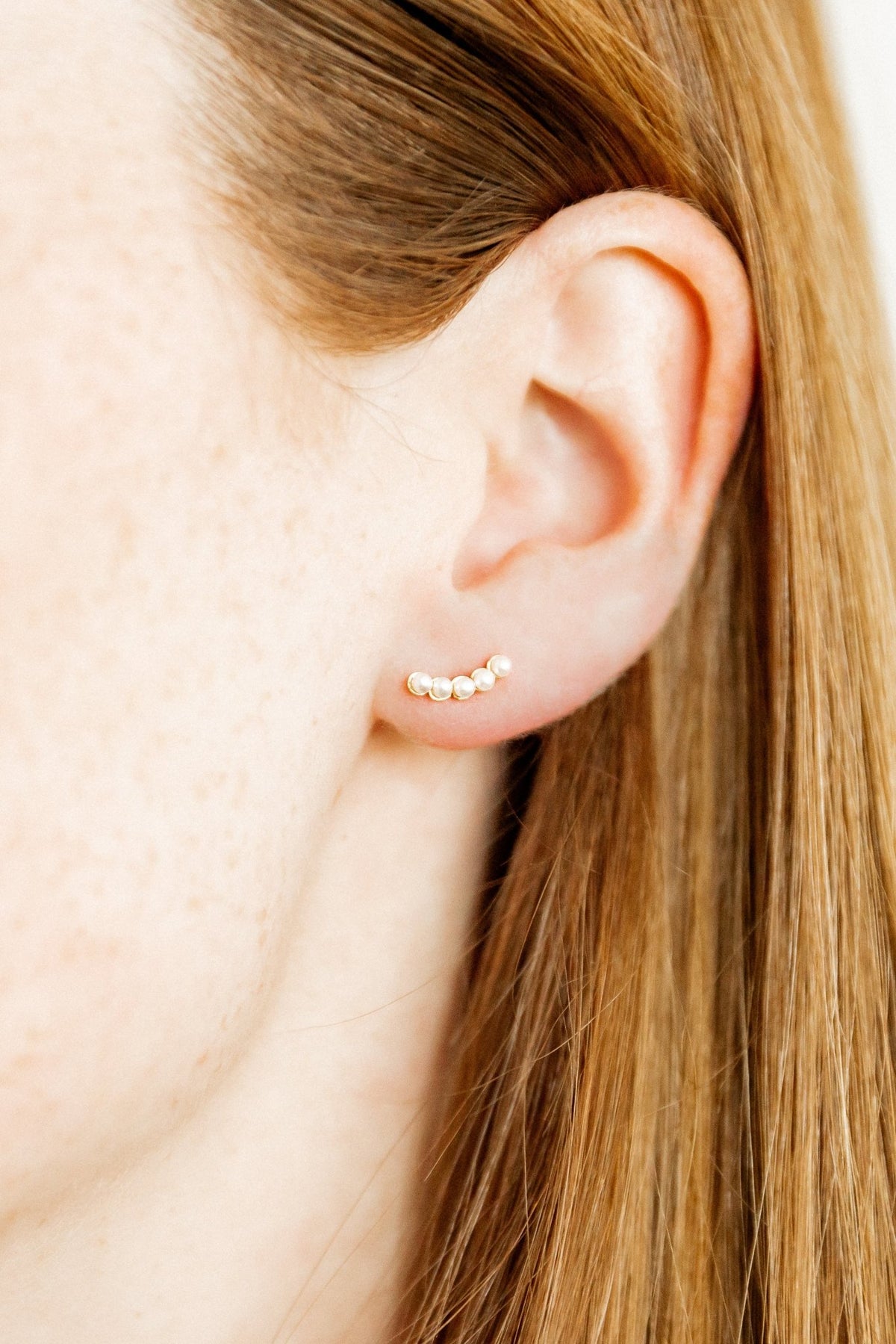 LINNY CO Abigail Pearl Gold screwback stud earrings for kids & little girls — hypoallergenic, waterproof stainless steel with secure screwback backs, shown on model.