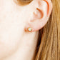 LINNY CO Addison Clear Gold screwback stud earrings for kids & little girls — hypoallergenic, waterproof stainless steel with secure screwback backs, shown on model.