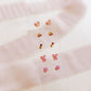 LINNY CO Alli Pink screwback stud earrings for kids & little girls — hypoallergenic, waterproof stainless steel with secure screwback backs, flat-lay styling.