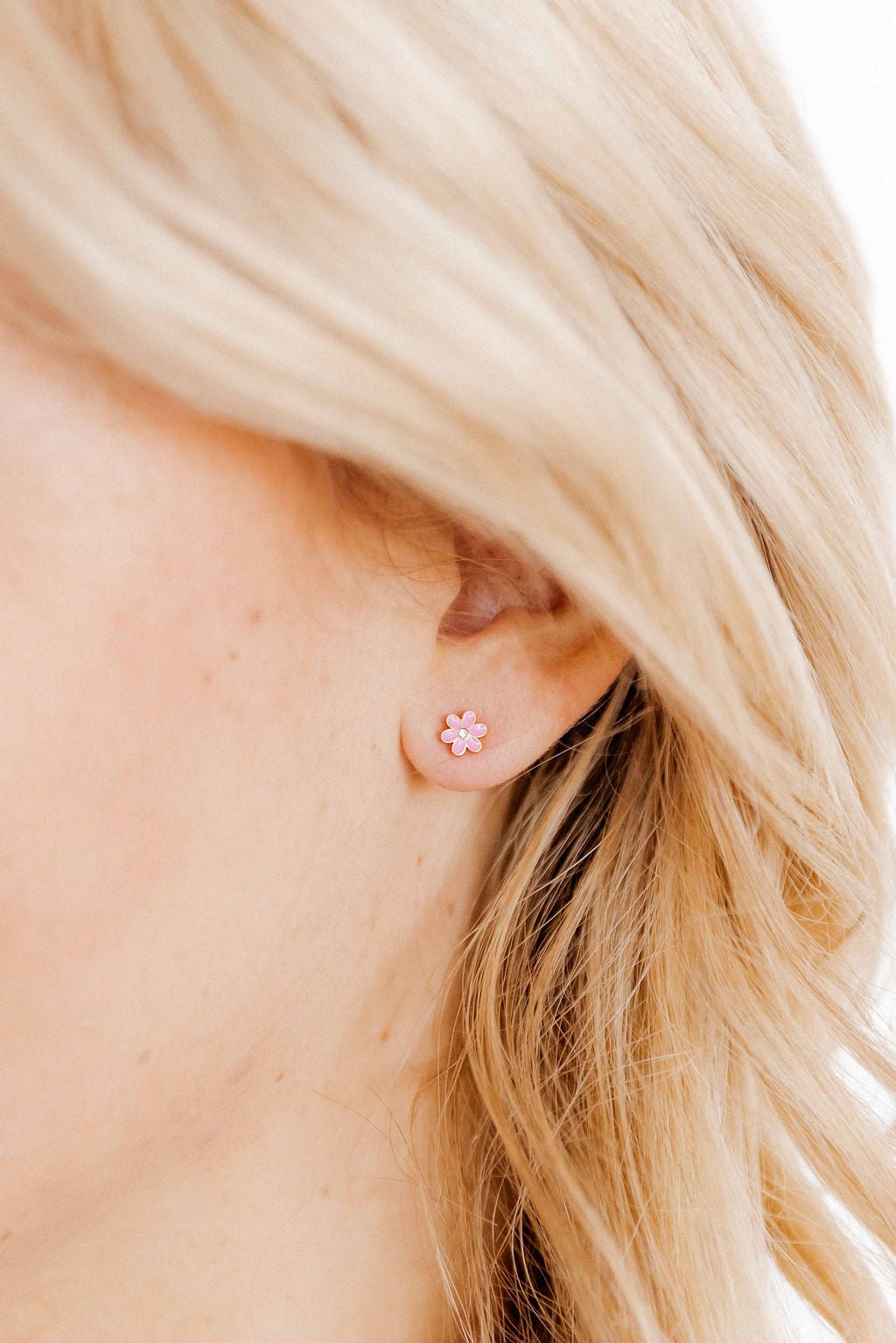 LINNY CO Alli Pink screwback stud earrings for kids & little girls — hypoallergenic, waterproof stainless steel with secure screwback backs, shown on model.