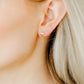 LINNY CO Becca screwback stud earrings for kids & little girls — hypoallergenic, waterproof stainless steel with secure screwback backs, shown on model.