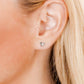 LINNY CO Billie Butterfly Silver screwback stud earrings for kids & little girls — hypoallergenic, waterproof stainless steel with secure screwback backs, shown on model.