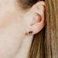 LINNY CO Black Bear screwback stud earrings for kids & little girls — hypoallergenic, waterproof stainless steel with secure screwback backs, shown on model.