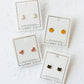 LINNY CO Black Cat screwback stud earrings for kids & little girls — hypoallergenic, waterproof stainless steel with secure screwback backs, flat-lay styling.