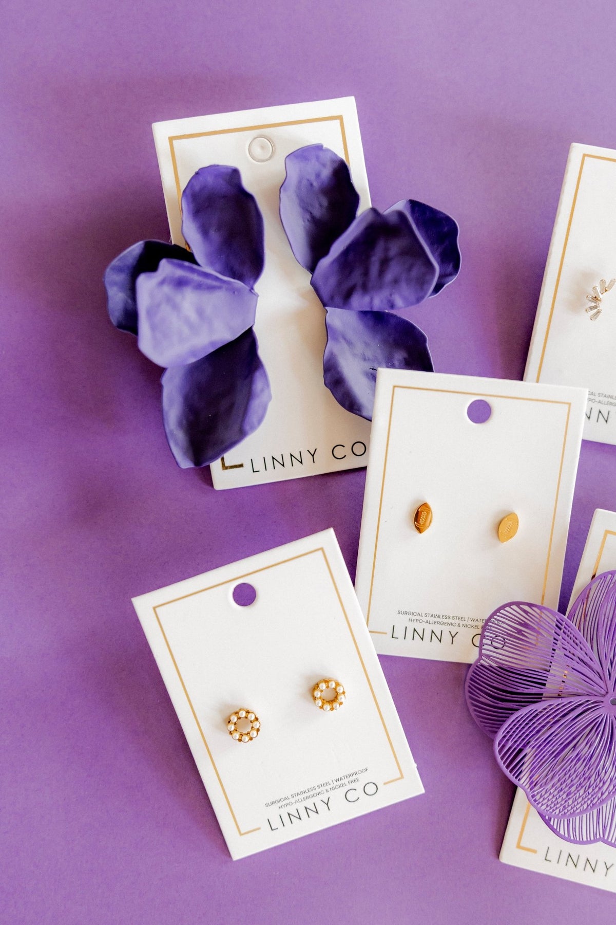 LINNY CO Brinley Pearl screwback stud earrings for kids & little girls — hypoallergenic, waterproof stainless steel with secure screwback backs, flat-lay styling.