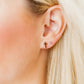 LINNY CO Catherine Cross Gold screwback stud earrings — hypoallergenic, waterproof stainless steel, shown on model.