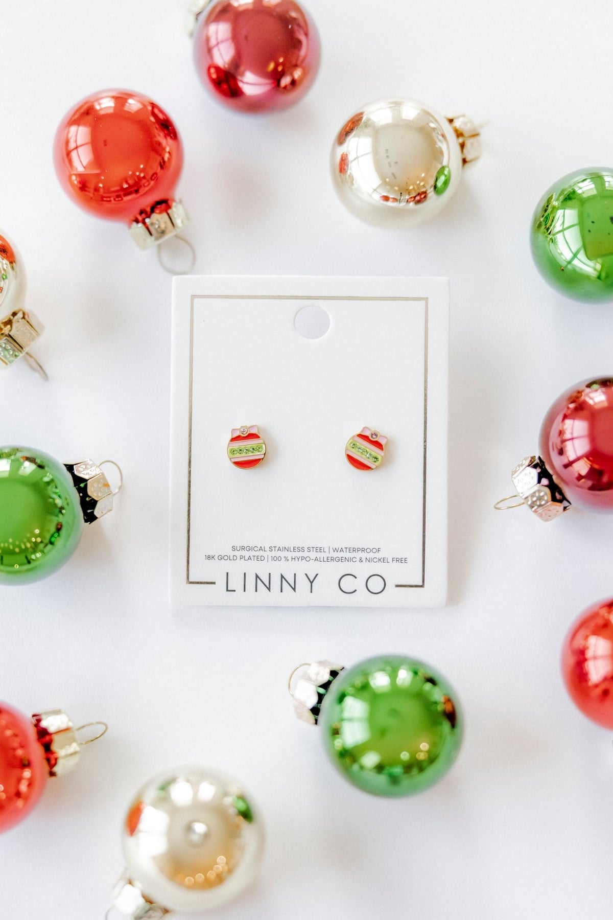 LINNY CO Chandler Ornament screwback stud earrings for kids & little girls — hypoallergenic, waterproof stainless steel with secure screwback backs, flat-lay styling.