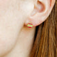 LINNY CO Chandler Ornament screwback stud earrings for kids & little girls — hypoallergenic, waterproof stainless steel with secure screwback backs, shown on model.