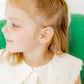 LINNY CO Clara Cross Gold Sparkle screwback stud earrings — hypoallergenic, waterproof stainless steel, shown on model.