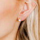 LINNY CO Heidi Pearl Bunny screwback stud earrings for kids & little girls — hypoallergenic, waterproof stainless steel with secure screwback backs, shown on model.