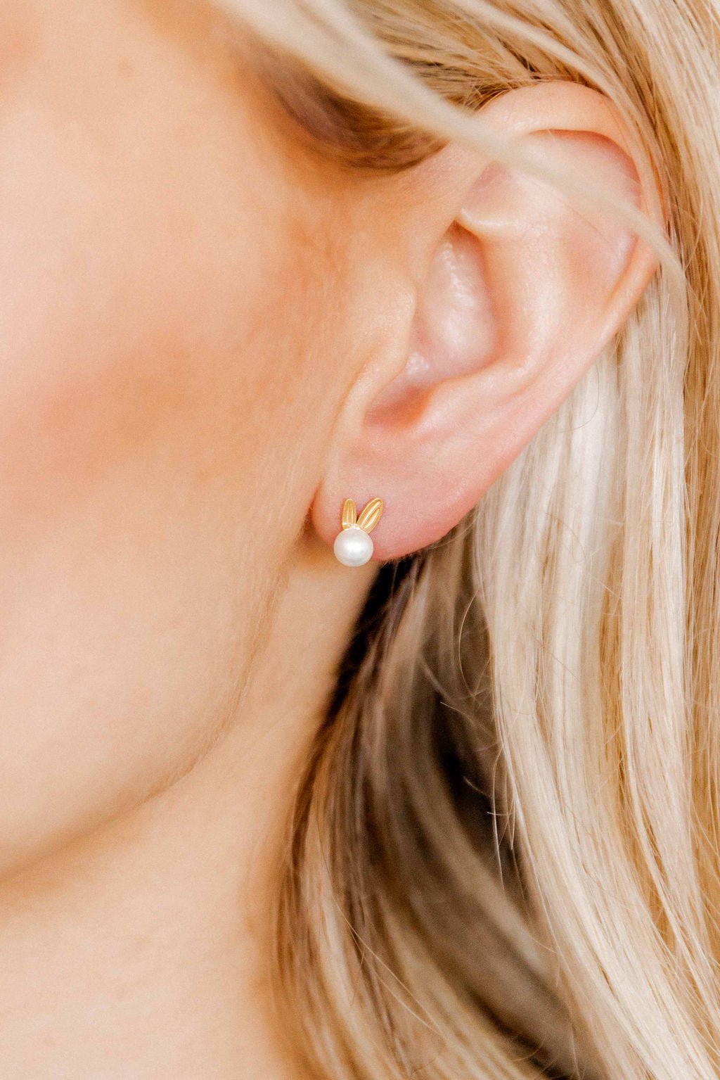 LINNY CO Heidi Pearl Bunny screwback stud earrings for kids & little girls — hypoallergenic, waterproof stainless steel with secure screwback backs, shown on model.