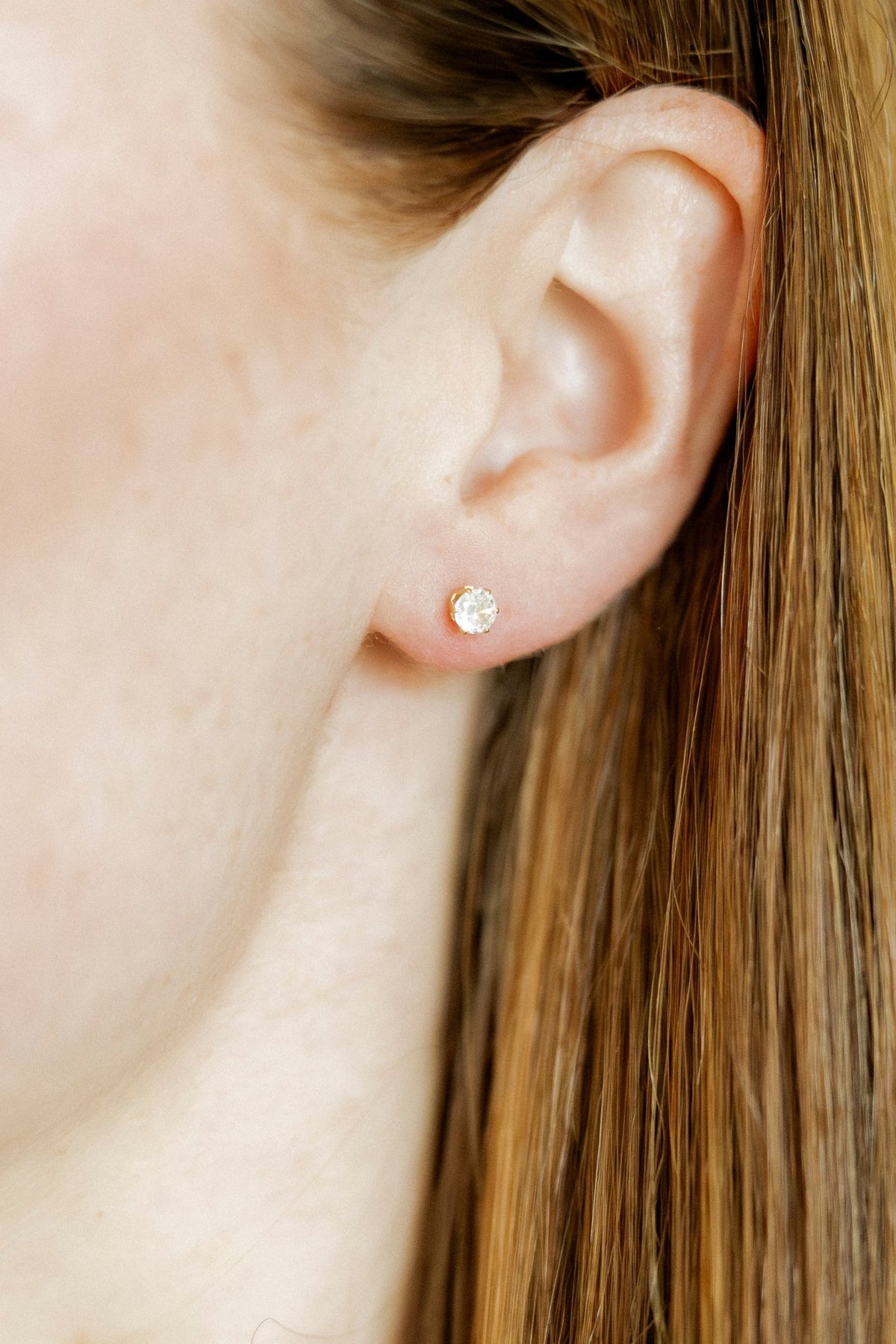LINNY CO Helen Gold screwback stud earrings for kids & little girls — hypoallergenic, waterproof stainless steel with secure screwback backs, shown on model.