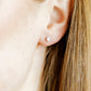 LINNY CO Helen Silver screwback stud earrings for kids & little girls — hypoallergenic, waterproof stainless steel with secure screwback backs, shown on model.