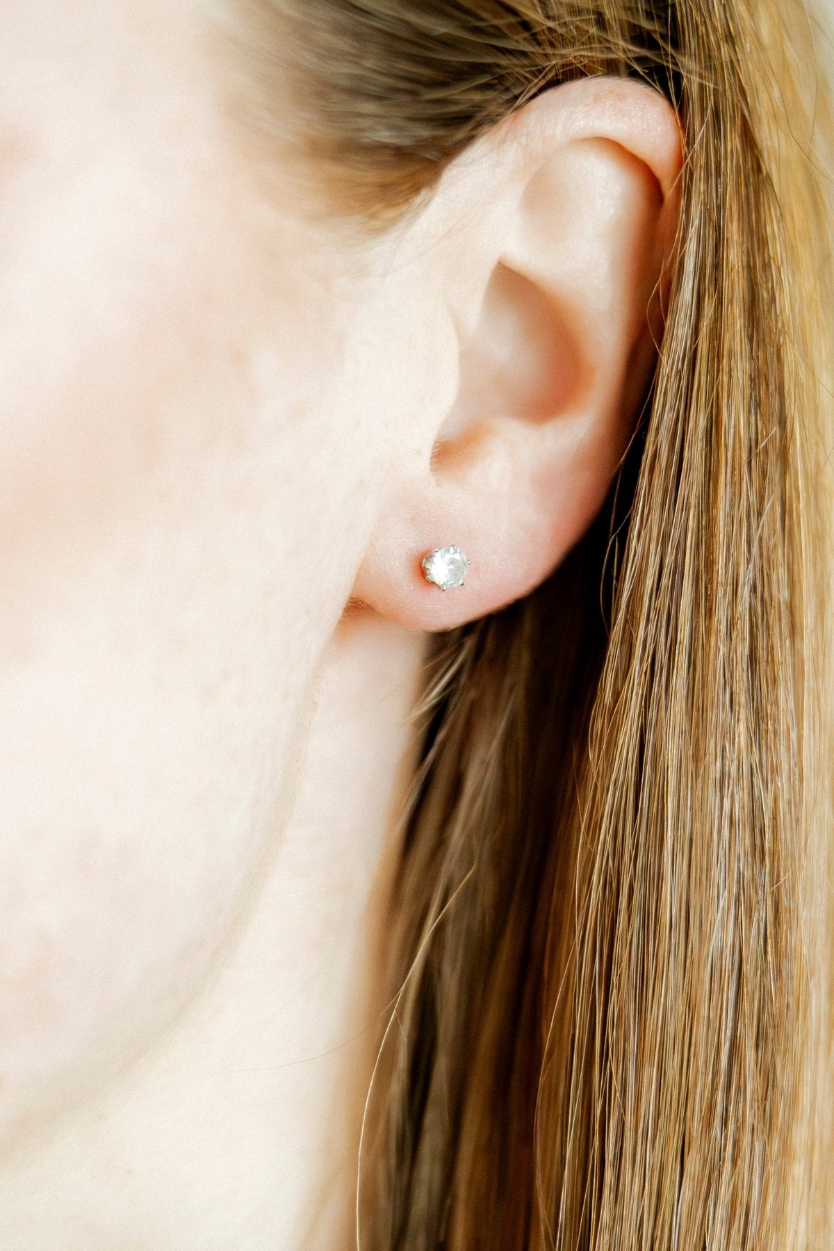 LINNY CO Helen Silver screwback stud earrings for kids & little girls — hypoallergenic, waterproof stainless steel with secure screwback backs, shown on model.