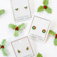 LINNY CO Holly Berry screwback stud earrings for kids & little girls — hypoallergenic, waterproof stainless steel with secure screwback backs, flat-lay styling.