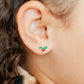 LINNY CO Holly Berry screwback stud earrings for kids & little girls — hypoallergenic, waterproof stainless steel with secure screwback backs, shown on model.