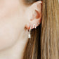 LINNY CO Horseshoe Silver screwback stud earrings for kids & little girls — hypoallergenic, waterproof stainless steel with secure screwback backs, shown on model.