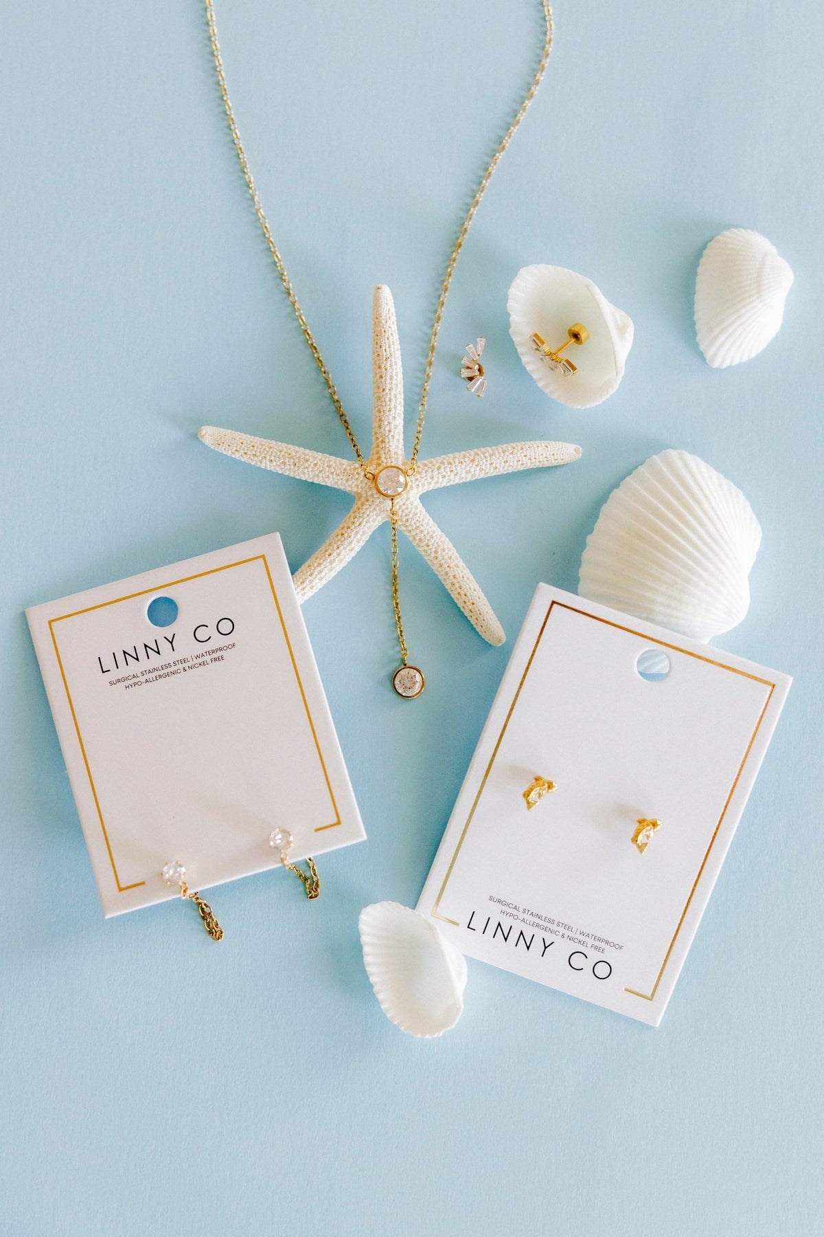 LINNY CO Indy Gold screwback stud earrings for kids & little girls — hypoallergenic, waterproof stainless steel with secure screwback backs, flat-lay styling.