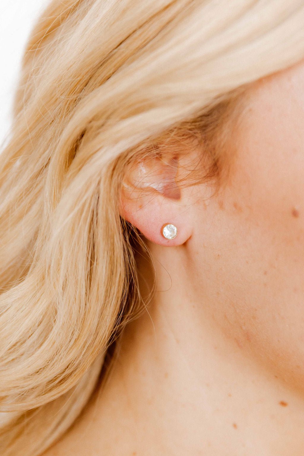 LINNY CO Juliet Clear 5mm screwback stud earrings for kids & little girls — hypoallergenic, waterproof stainless steel with secure screwback backs, shown on model.
