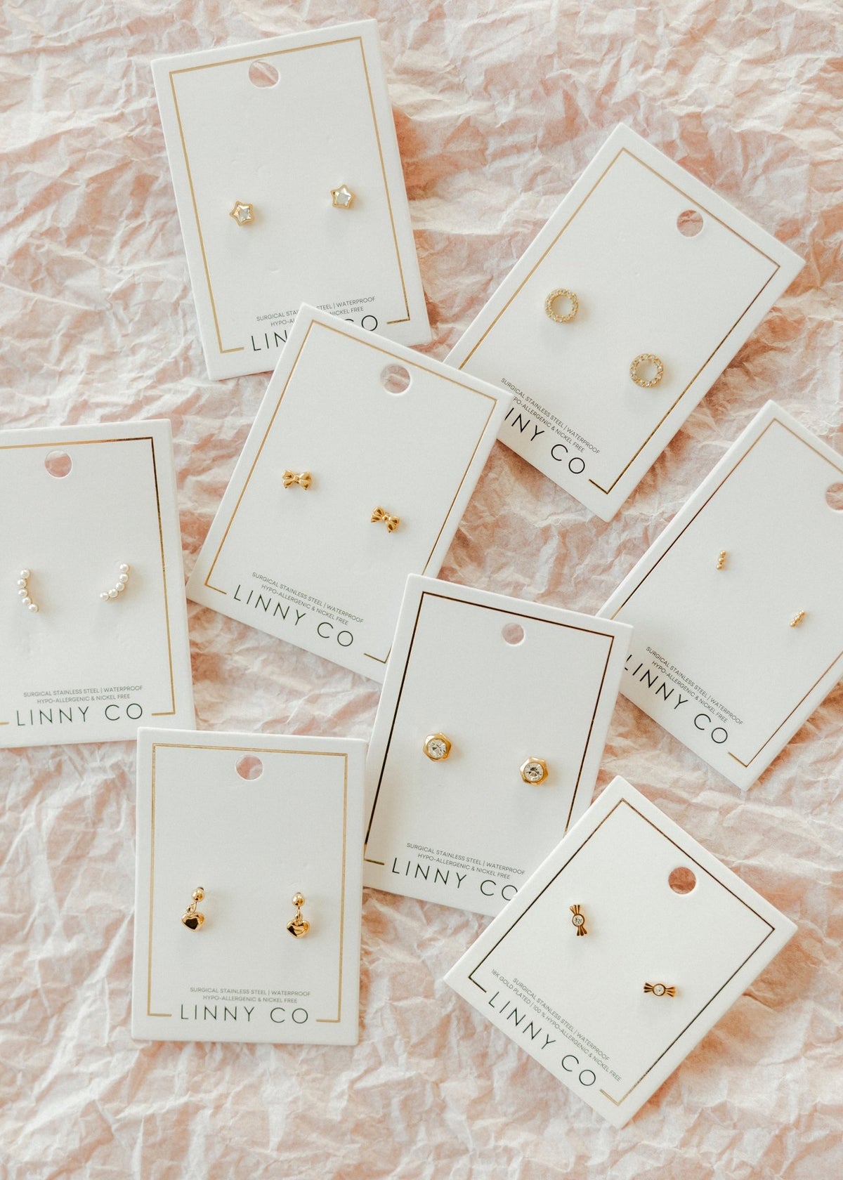 LINNY CO Kate Candy Gold screwback stud earrings for kids & little girls — hypoallergenic, waterproof stainless steel with secure screwback backs, flat-lay styling.