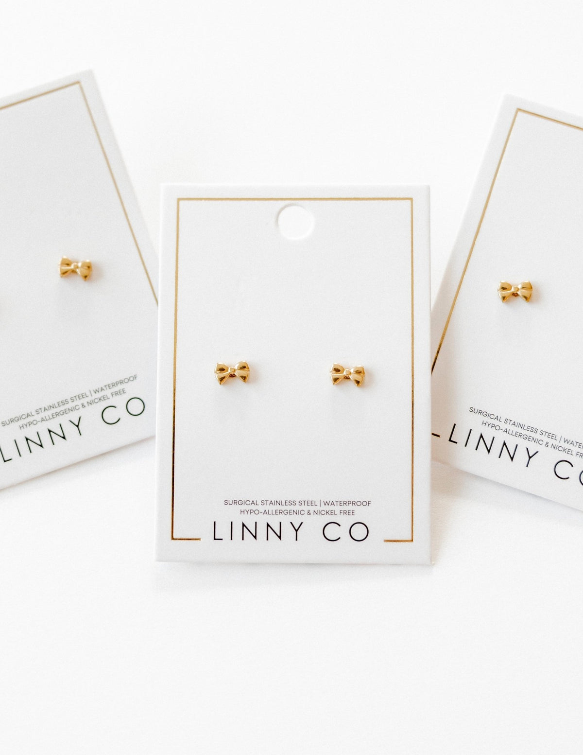 LINNY CO Kate Candy Gold screwback stud earrings for kids & little girls — hypoallergenic, waterproof stainless steel with secure screwback backs, flat-lay styling.