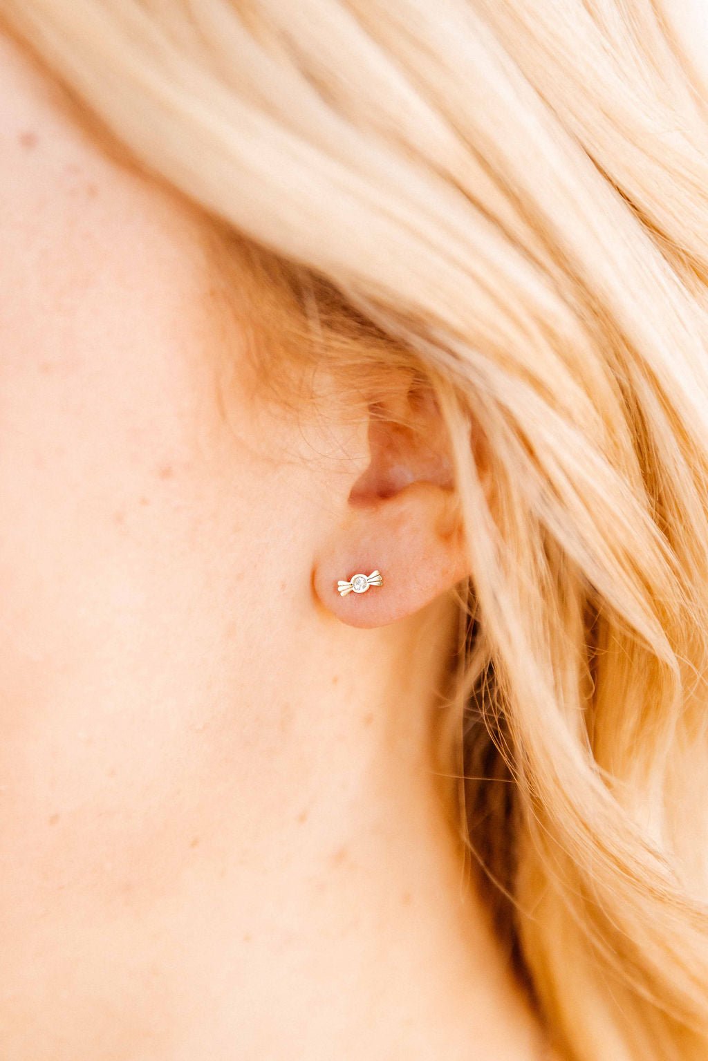 LINNY CO Kate Candy Gold screwback stud earrings for kids & little girls — hypoallergenic, waterproof stainless steel with secure screwback backs, shown on model.