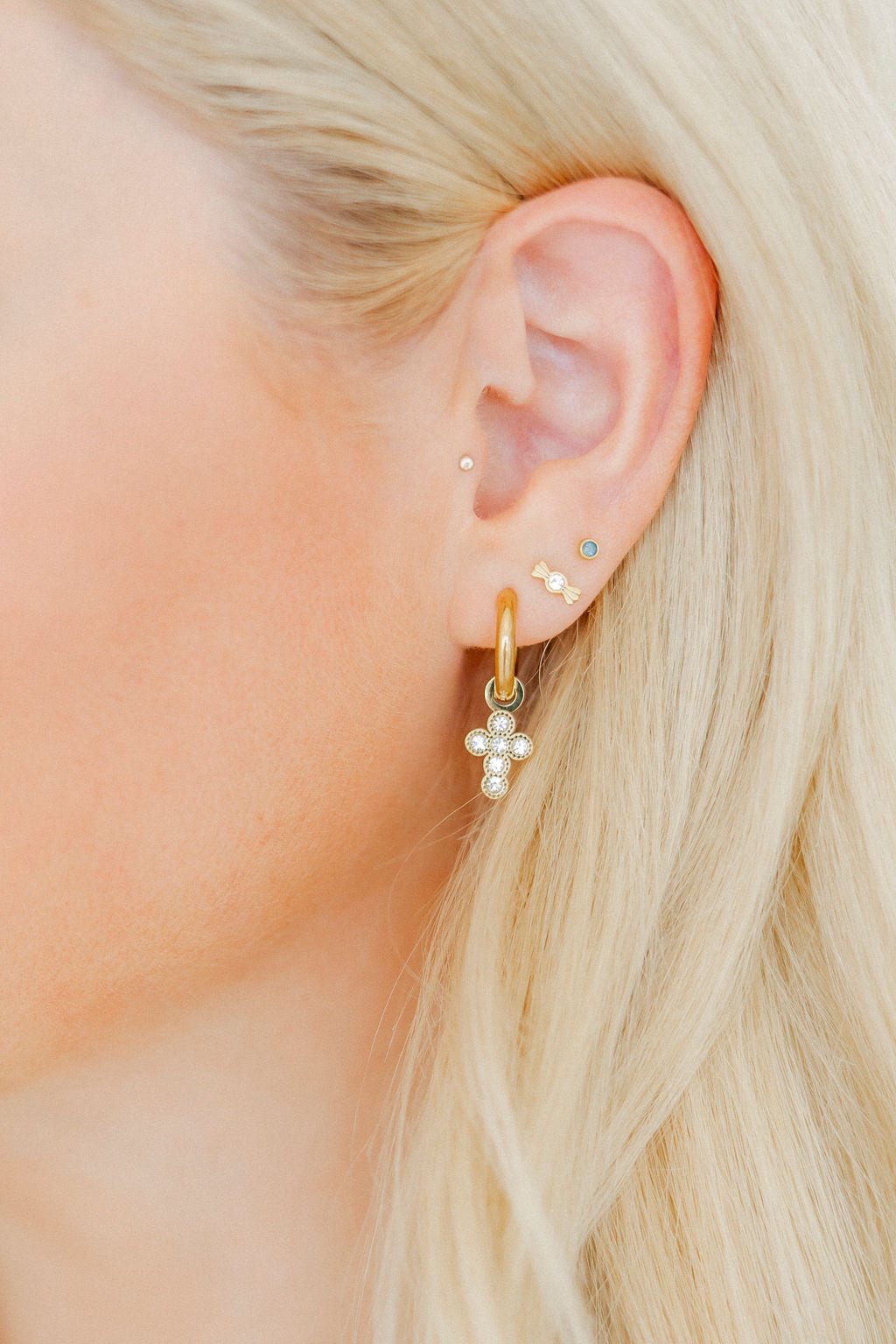 LINNY CO Kate Candy Gold screwback stud earrings for kids & little girls — hypoallergenic, waterproof stainless steel with secure screwback backs, shown on model.
