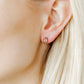 LINNY CO Kay Pink screwback stud earrings for kids & little girls — hypoallergenic, waterproof stainless steel with secure screwback backs, shown on model.