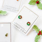 LINNY CO Leighton Wreath screwback stud earrings for kids & little girls — hypoallergenic, waterproof stainless steel with secure screwback backs, flat-lay styling.