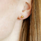 LINNY CO Lydia Gold screwback stud earrings for kids & little girls — hypoallergenic, waterproof stainless steel with secure screwback backs, shown on model.