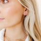 LINNY CO Madison Gold Clear screwback stud earrings for kids & little girls — hypoallergenic, waterproof stainless steel with secure screwback backs, shown on model.