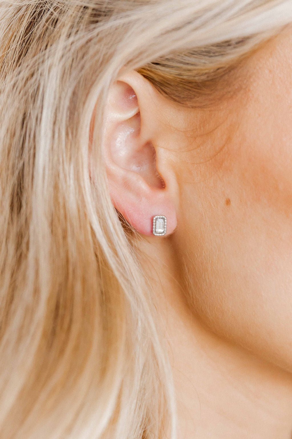 LINNY CO Madison Silver Clear screwback stud earrings for kids & little girls — hypoallergenic, waterproof stainless steel with secure screwback backs, shown on model.