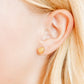 LINNY CO Marina Shell screwback stud earrings for kids & little girls — hypoallergenic, waterproof stainless steel with secure screwback backs, shown on model.