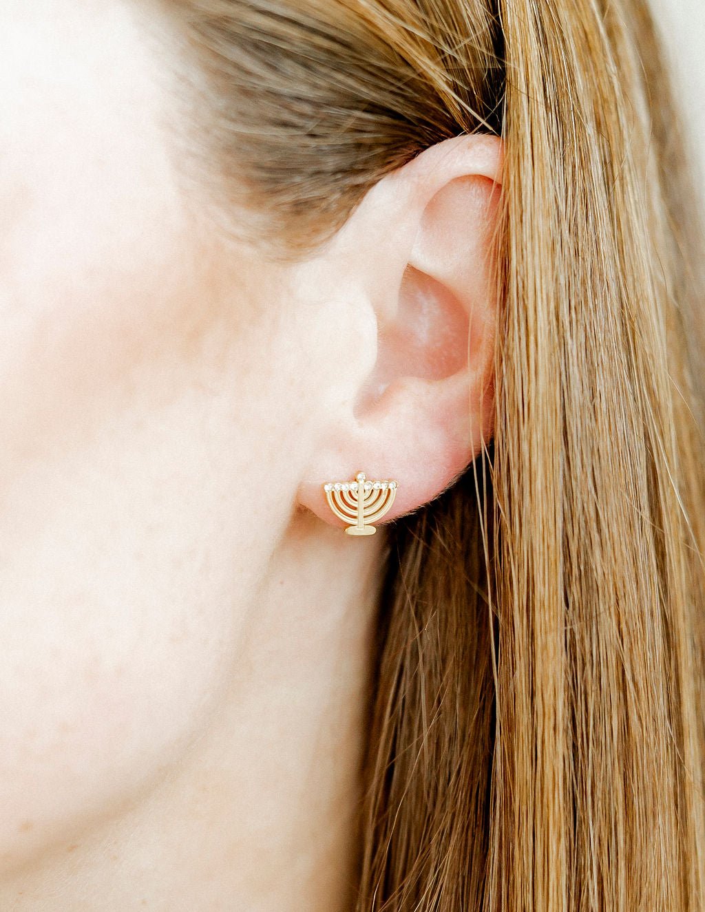 LINNY CO Menorah screwback stud earrings for kids & little girls — hypoallergenic, waterproof stainless steel with secure screwback backs, shown on model.