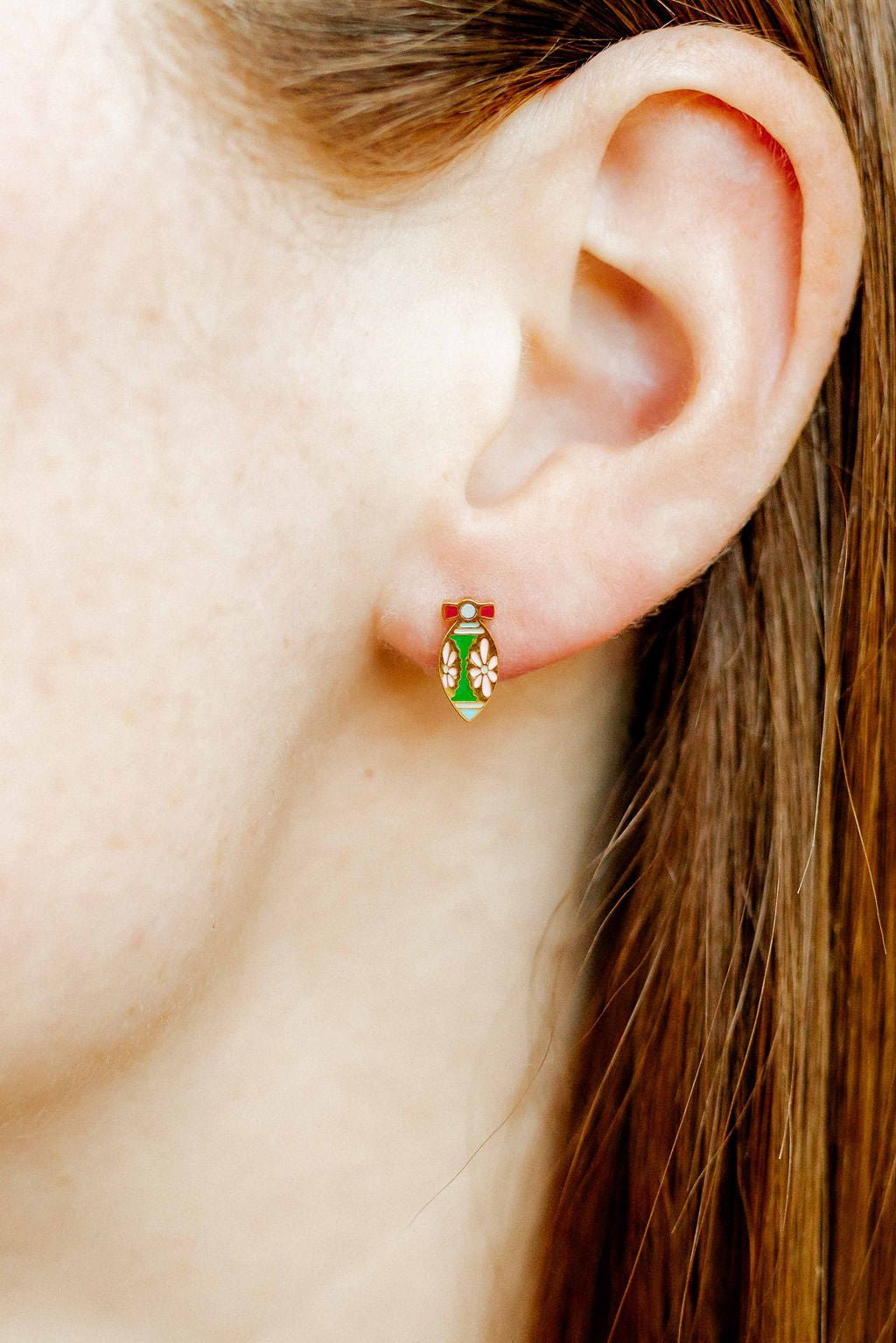 LINNY CO Merritt Ornament screwback stud earrings for kids & little girls — hypoallergenic, waterproof stainless steel with secure screwback backs, shown on model.