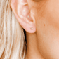 LINNY CO Micro Helen Silver screwback stud earrings for kids & little girls — hypoallergenic, waterproof stainless steel with secure screwback backs, shown on model.