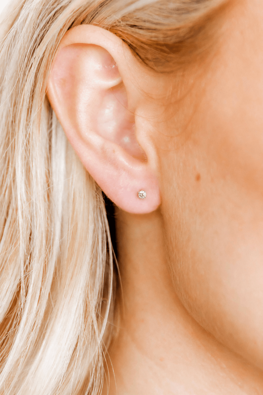 LINNY CO Micro Helen Silver screwback stud earrings for kids & little girls — hypoallergenic, waterproof stainless steel with secure screwback backs, shown on model.