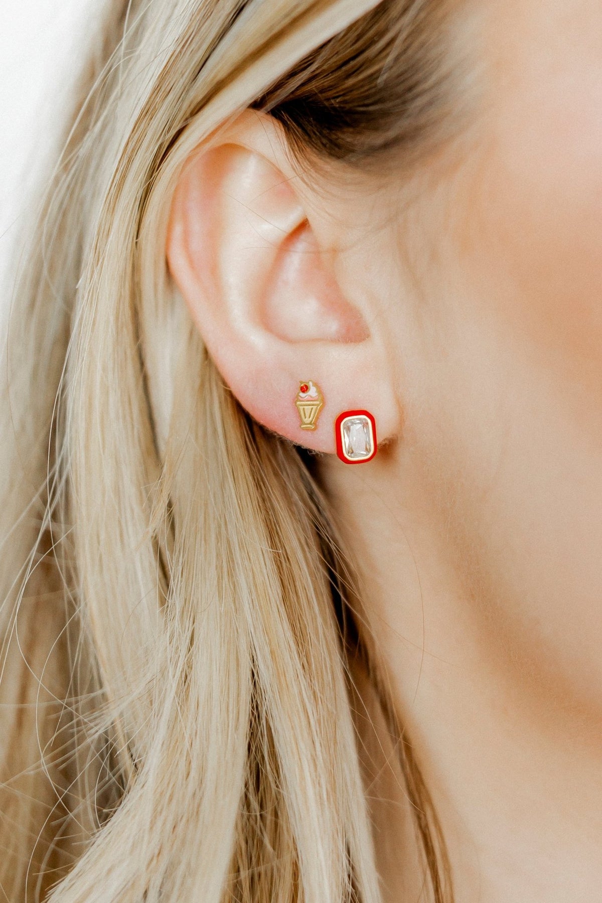 LINNY CO Milkshake screwback stud earrings for kids & little girls — hypoallergenic, waterproof stainless steel with secure screwback backs, shown on model.